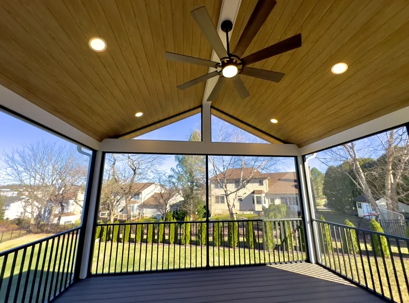 back patio with fan and railing
